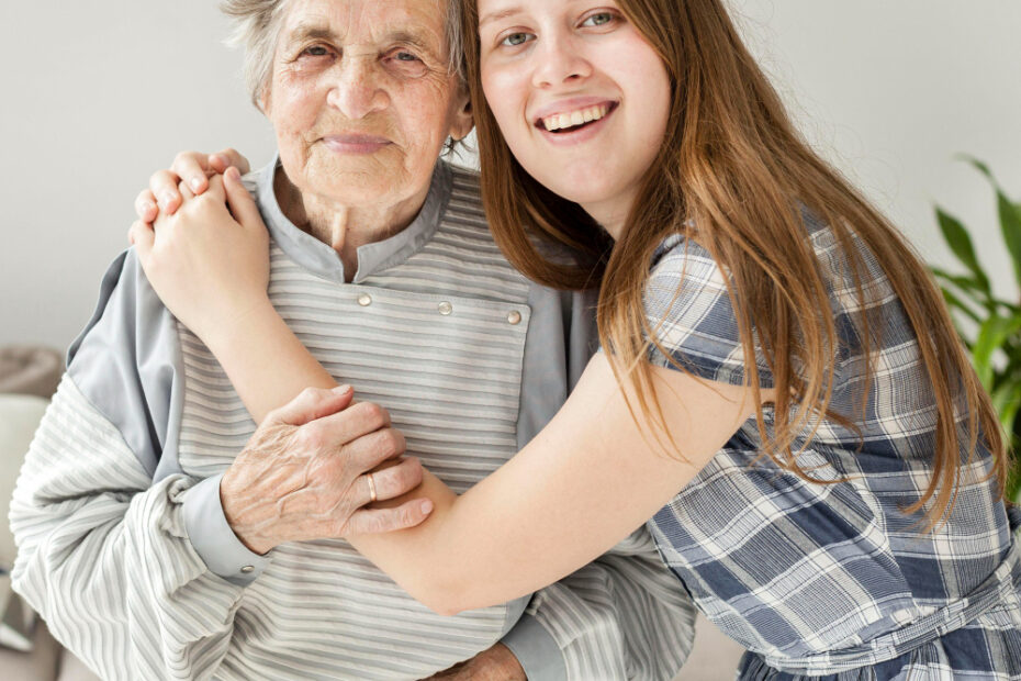 A young woman embracing an elderly lady, symbolising family connection, care, and intergenerational love.