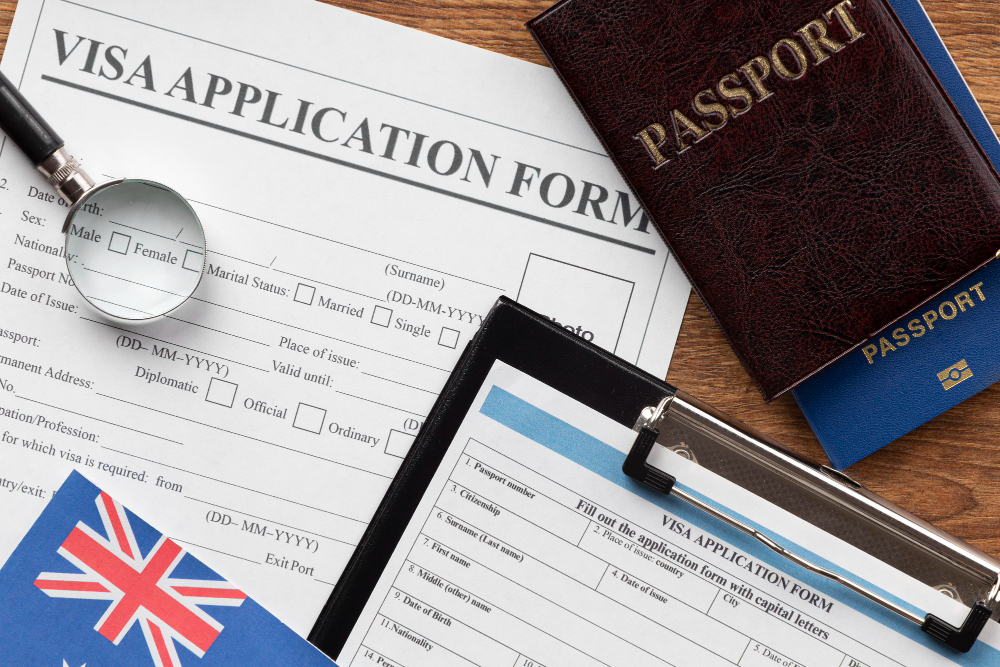 Visa application form with British flag, passport, and documents, representing the process of applying for Indefinite Leave to Remain (ILR) in the UK.