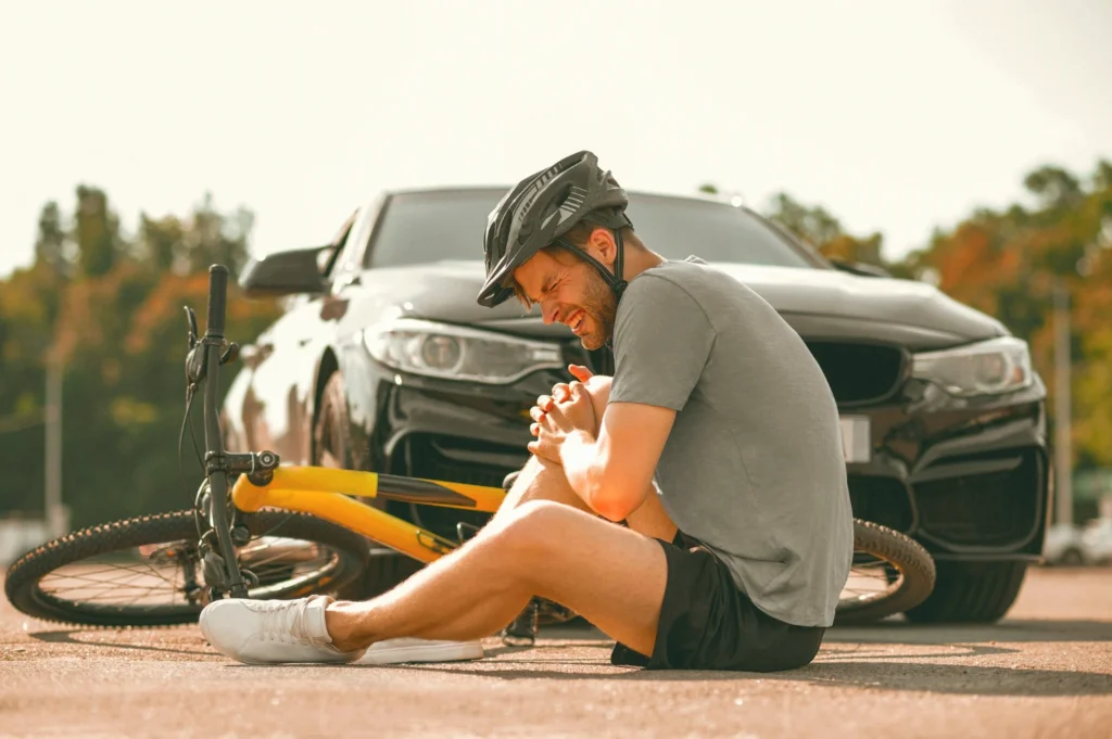 A man fell on his bike after a car hit him