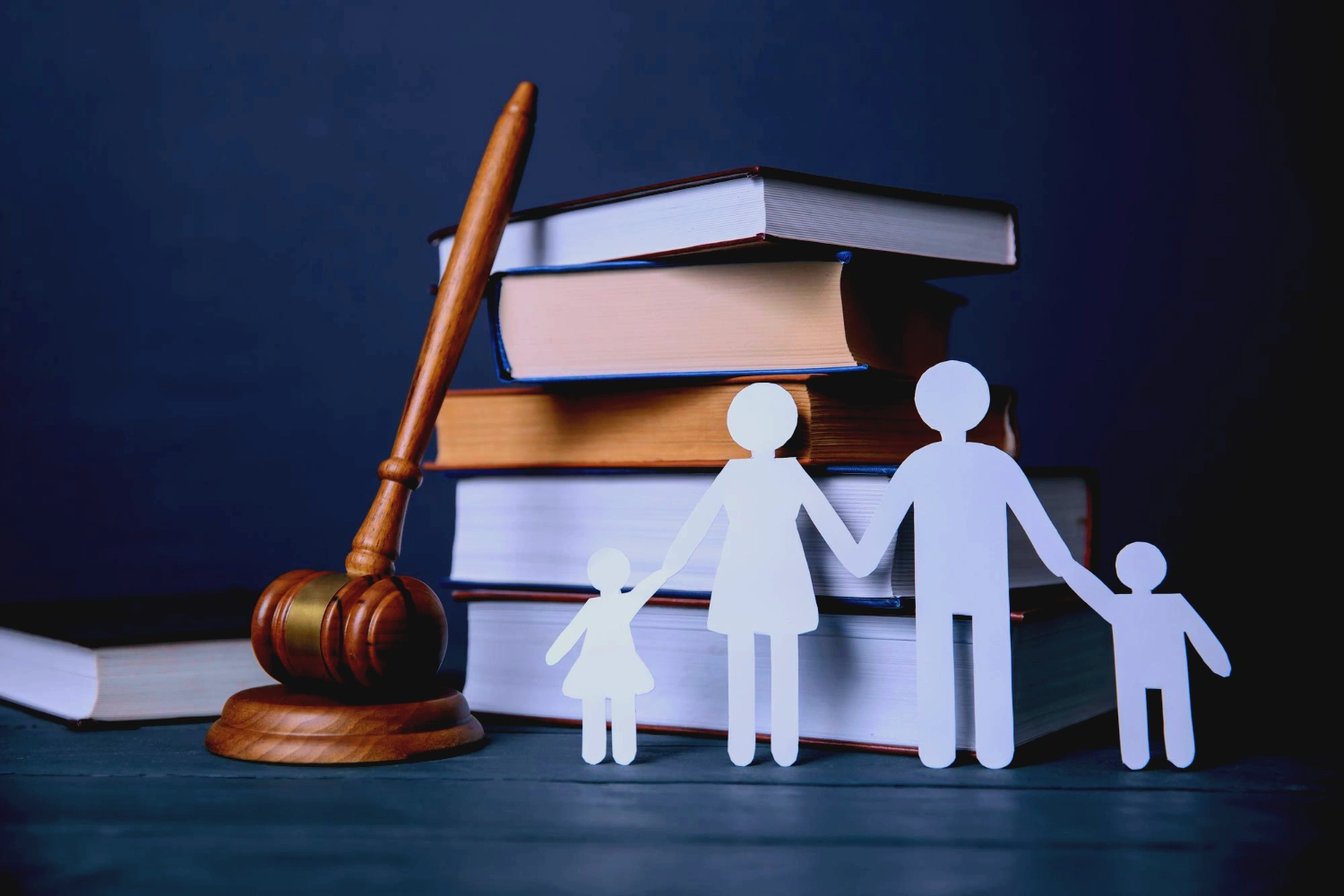 A family cut out in front of books and a gavel next to it