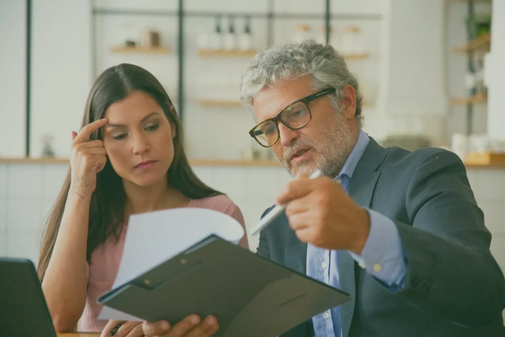 Professional advisor explaining legal documents to a client, representing professional negligence claims and legal advice services in the UK.