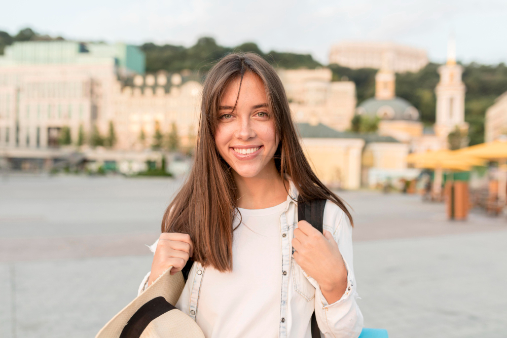 A woman who studied abroad, wearing graduation attire, symbolising post-study opportunities under the UK Graduation Route visa.